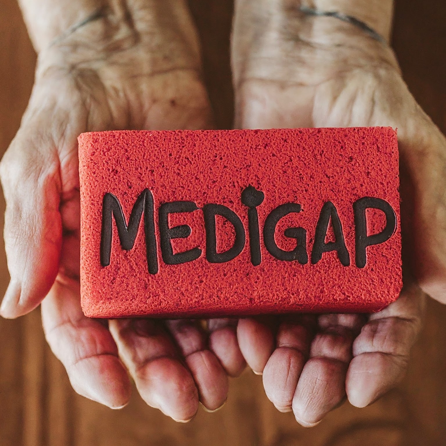 Hands holding out block that says "Medigap"