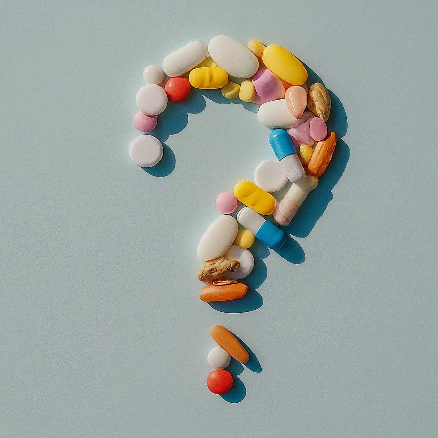 Prescription drugs in the shape of a question mark