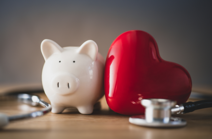 Advantage Plan concept; piggy bank with stethoscope and a heart sitting on a table