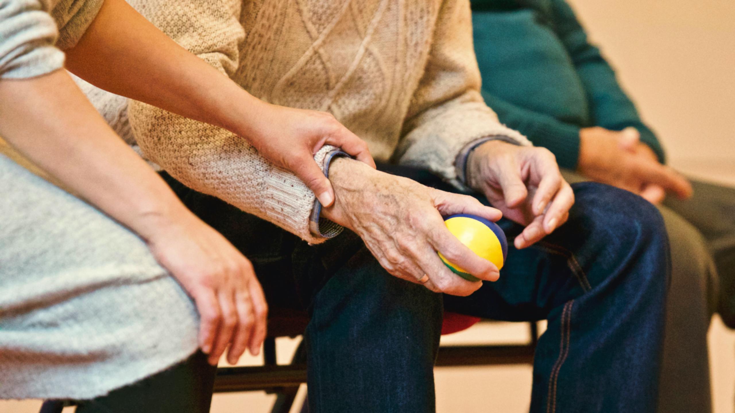 helping hand over seniors sitting on bench